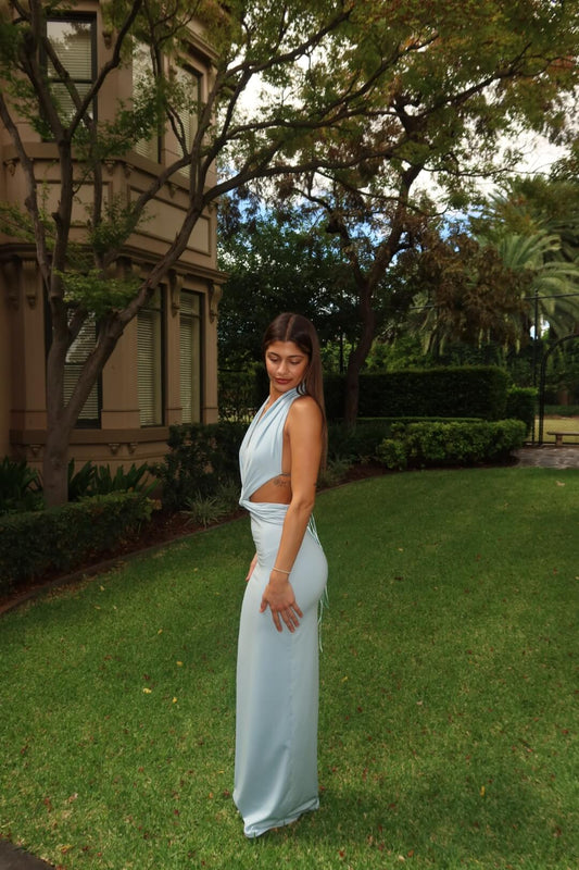 Side view of the Deconduarte Elin Maxi Dress in baby blue showcasing the flattering fitted silhouette