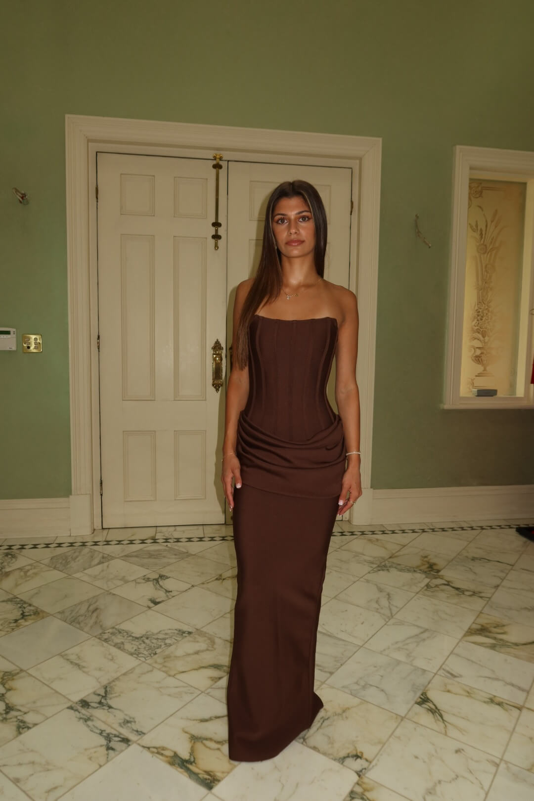 Three-quarter front view of the Eliya The Label Hilda Gown in chocolate showcasing the flattering fitted silhouette