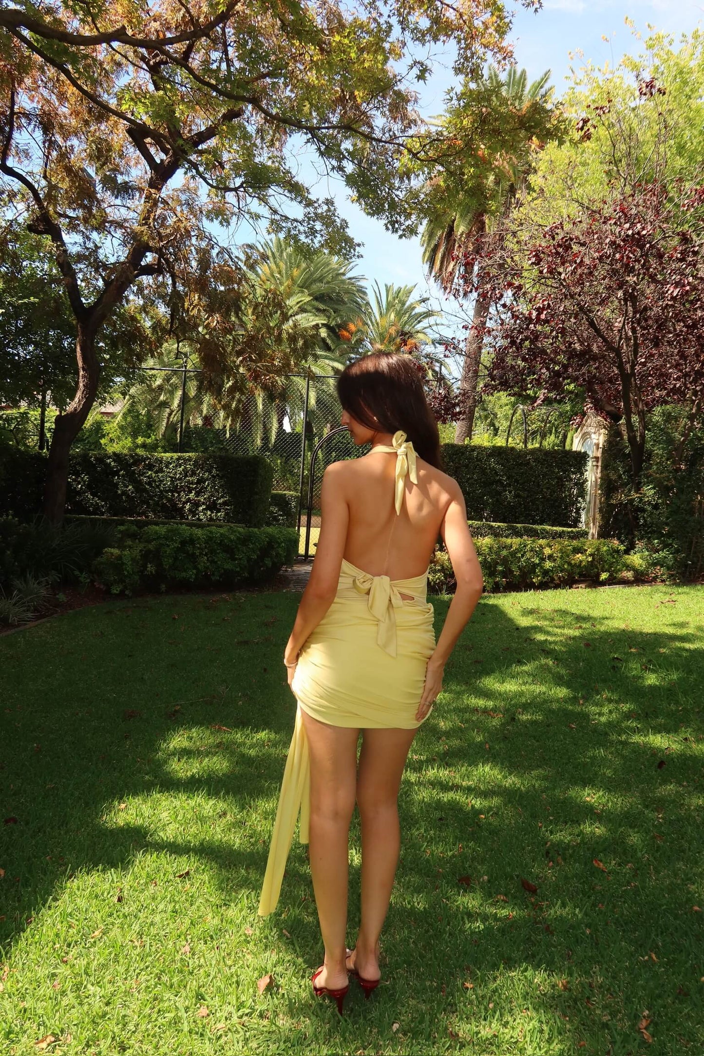 Back view of Imana Swim Kora Set in lemon highlighting the adjustable tie design and flattering silhouette, available for dress hire in Adelaide, Australia.