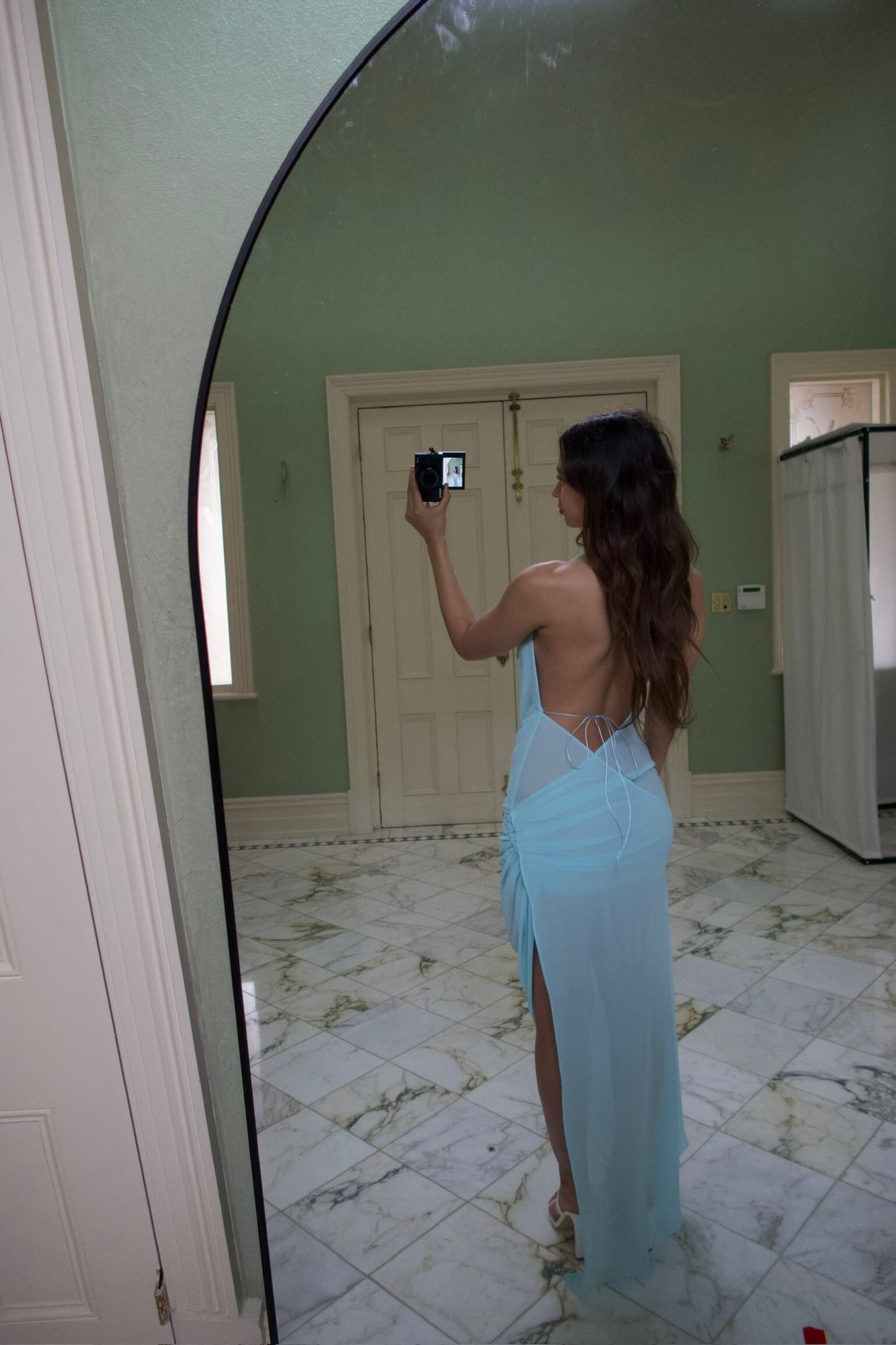Natalie Rolt Anastasia Maxi Dress in baby blue showcasing the open back design and flowing maxi silhouette
