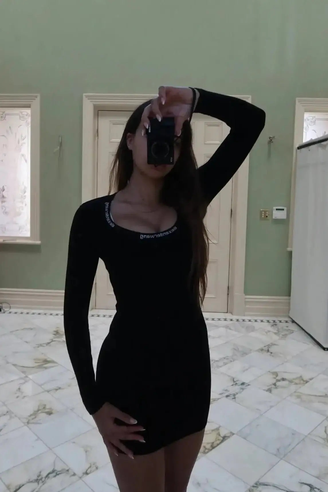 Alexander Wang long sleeve mini dress in black featuring crew neckline, fitted stretch jersey fabric and body skimming mini silhouette with minimalist design