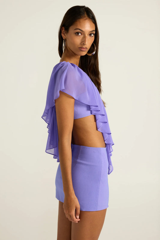 Ance Gria Clover Top & Mini Skirt Set in Periwinkle, alternate side view showing A-line skirt and ruffle drape, designer set hire Adelaide Australia