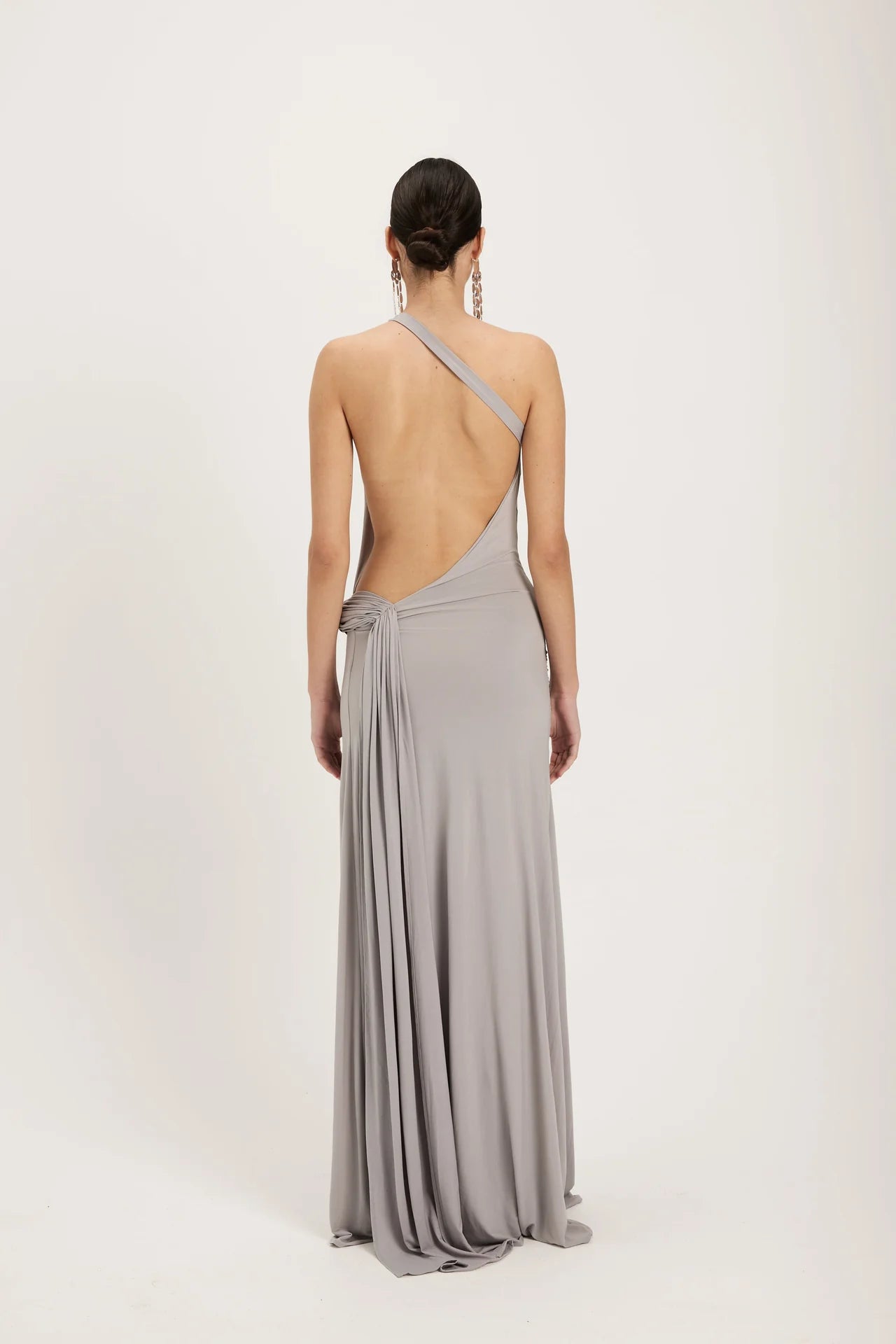 Back detail of silver grey gown highlighting structured corset design and smooth metallic finish