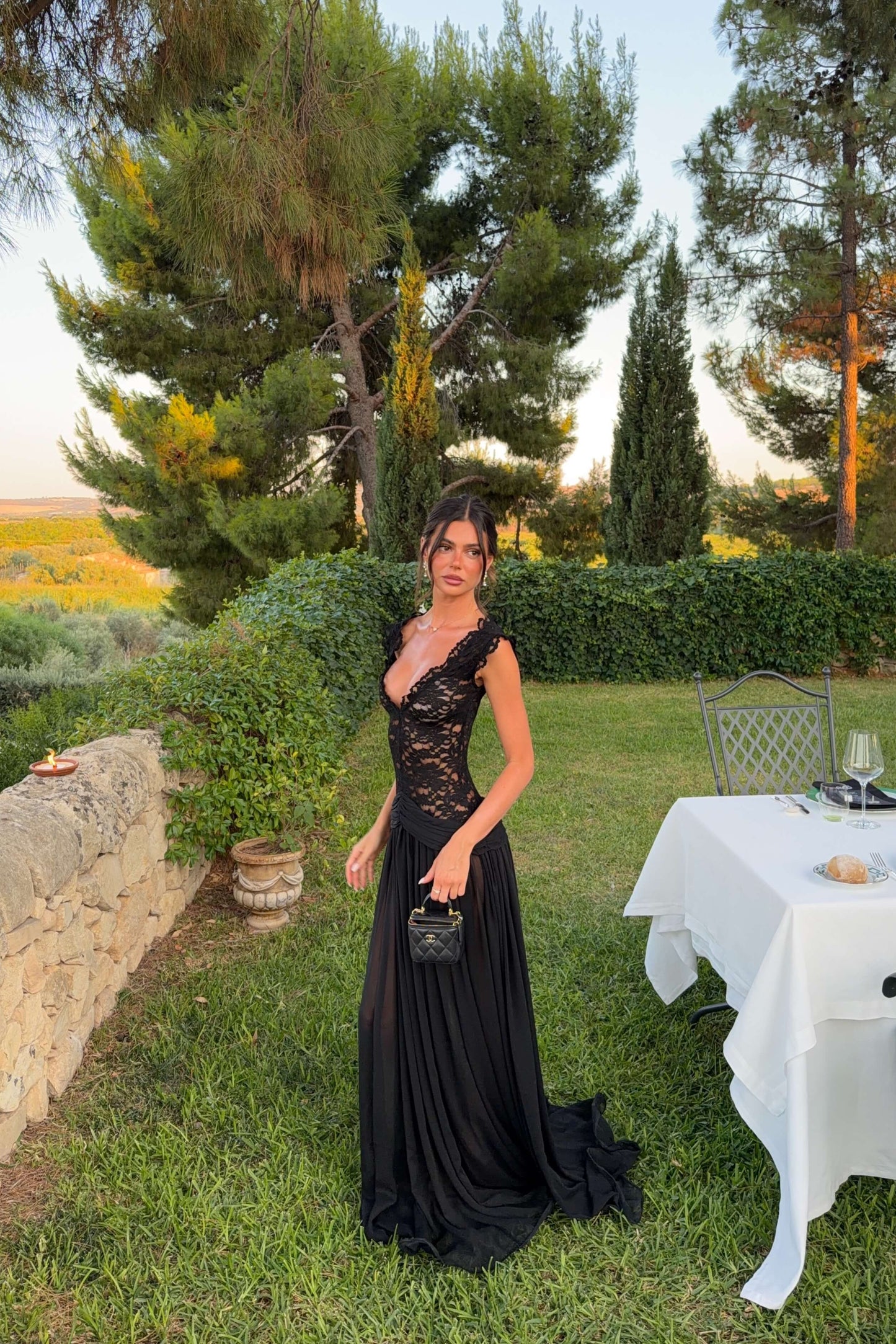 Full-length view of the Arcina Ori Arabella black formal gown with elegant off-shoulder neckline and sheer skirt, available for designer dress hire in Adelaide.