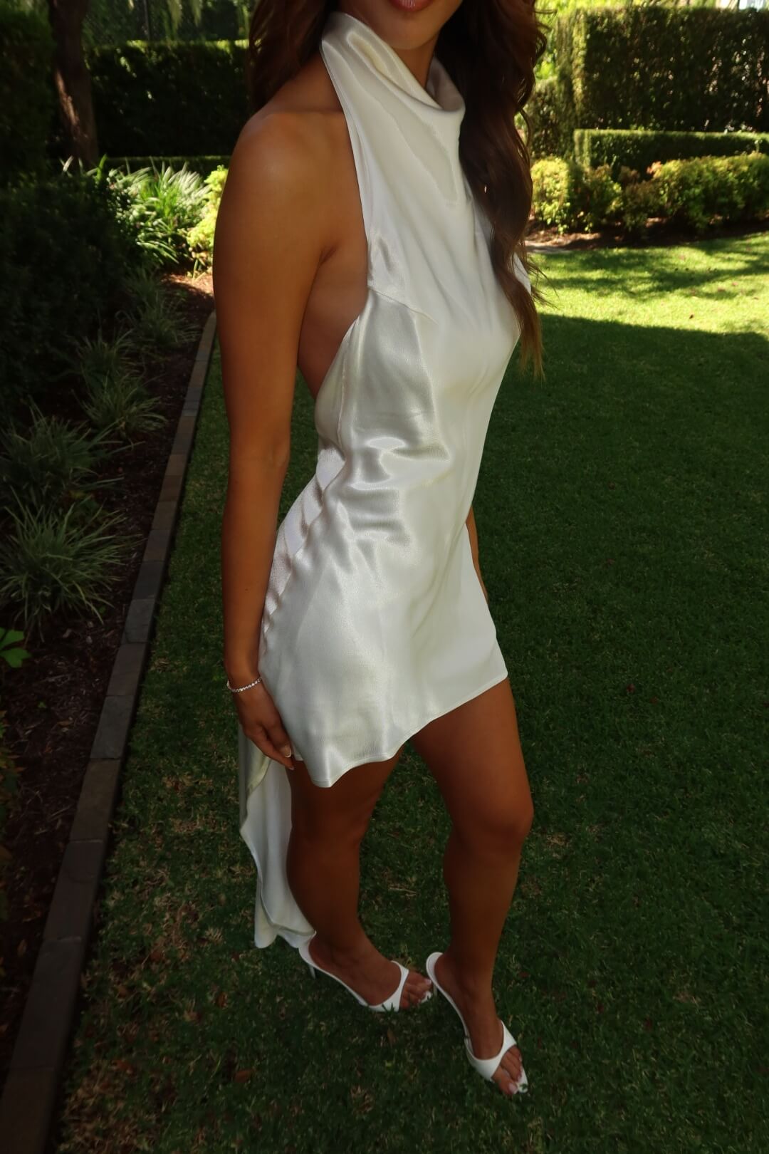 Three-quarter side view of the Asa Fields Florence Gown in white showcasing the flattering silhouette and elegant drape