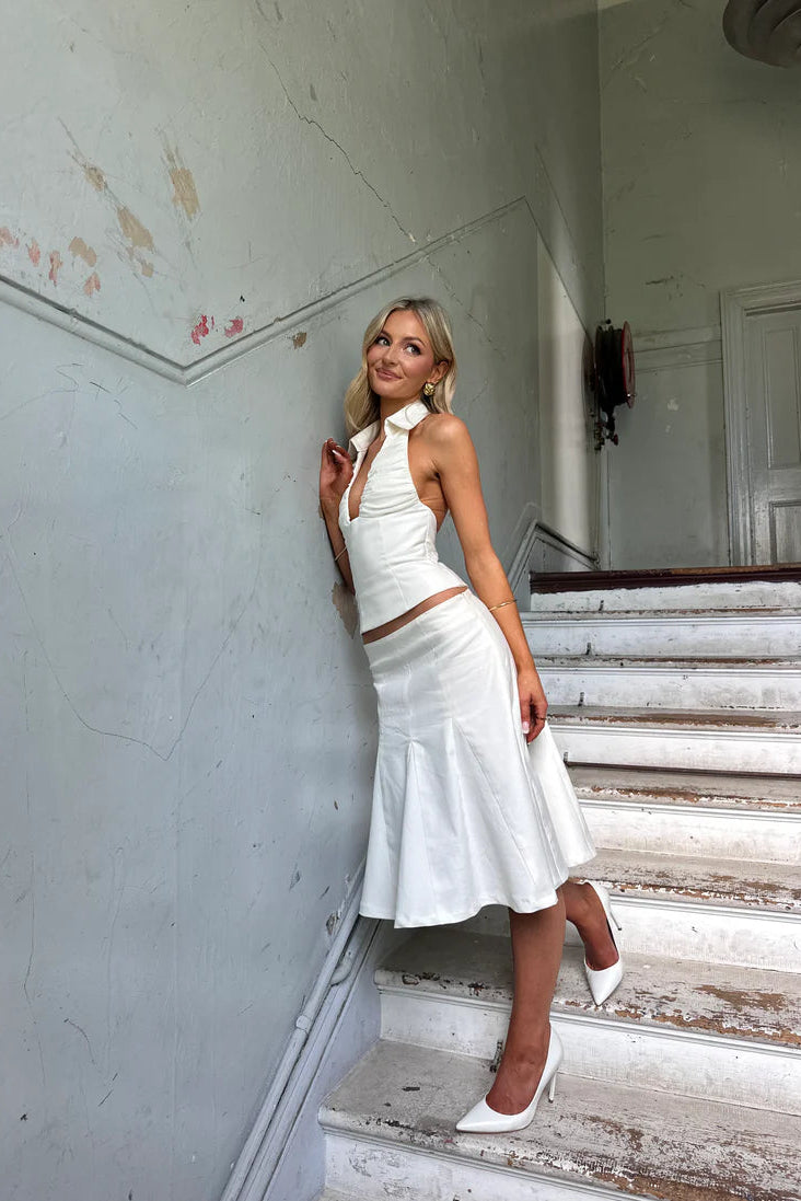 White mini skirt detail showing tailored fit, structured seams and clean hem finish