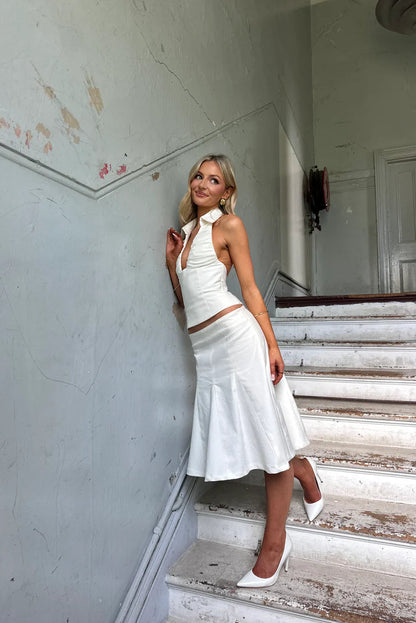 White mini skirt detail showing tailored fit, structured seams and clean hem finish