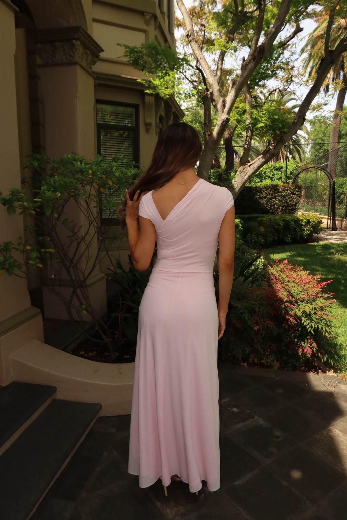 Back view of Bec & Bridge Susie Maxi Dress in ballet pink with asymmetric cut-out back