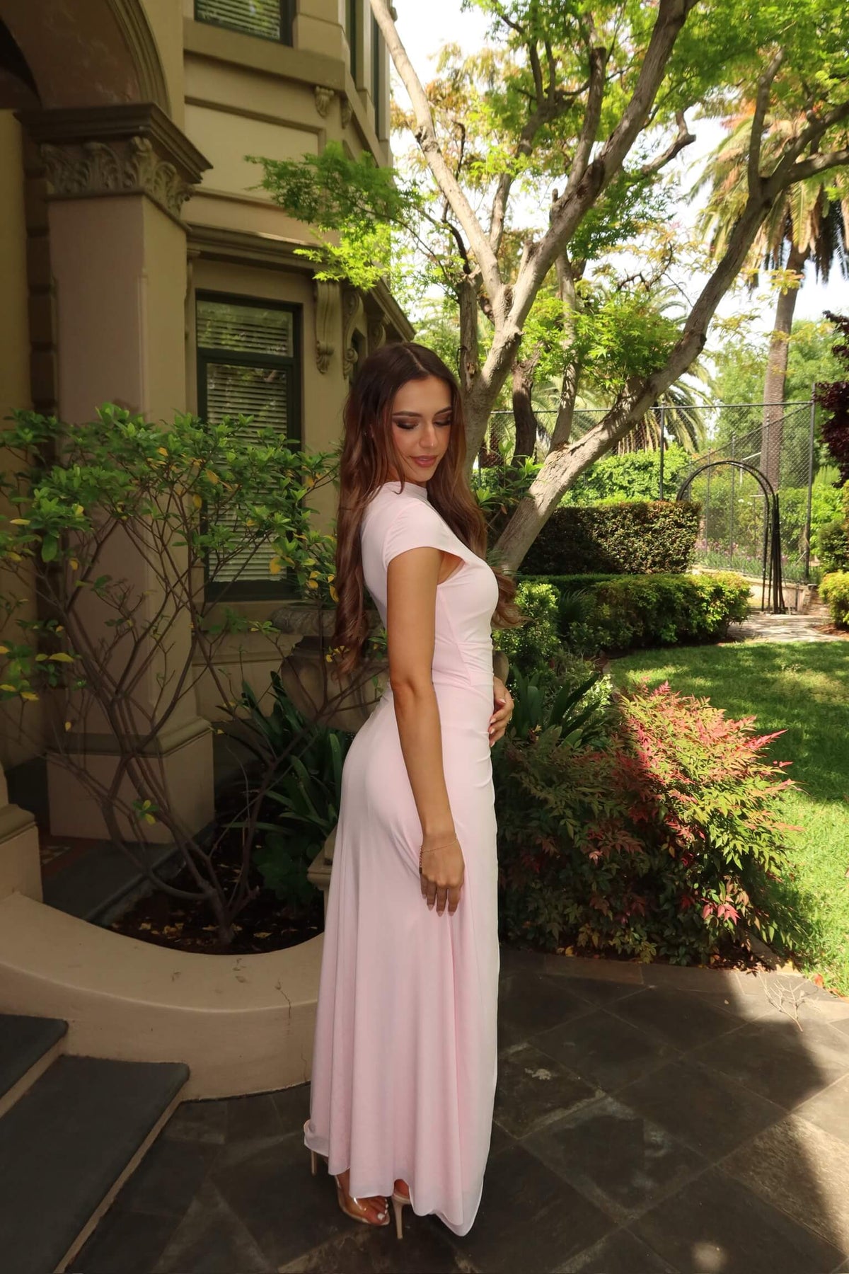 Side view of Bec & Bridge Susie Maxi Dress in ballet pink showing its body-skimming silhouette