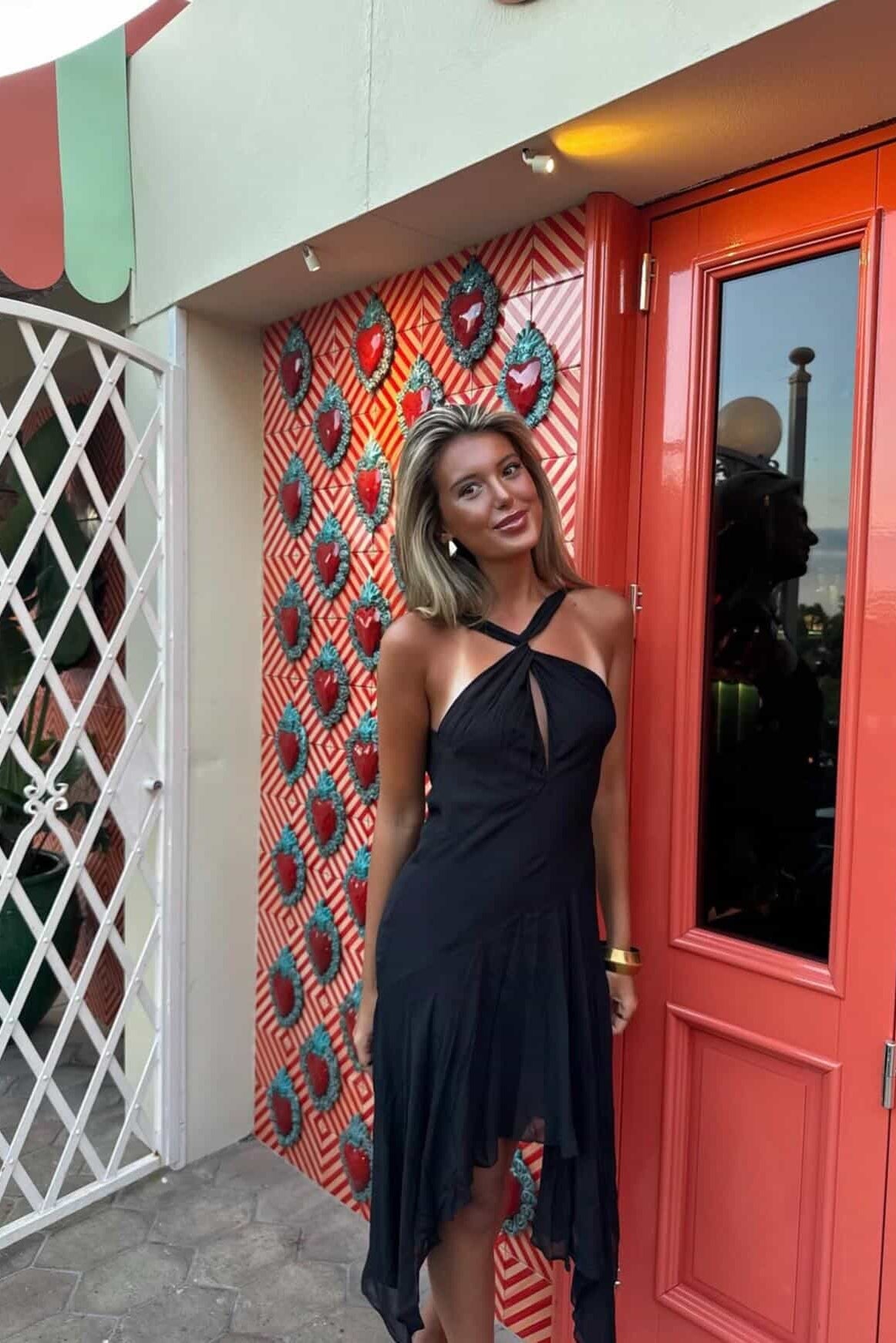 Black halter maxi dress with body skimming fit and elegant straight floor length design