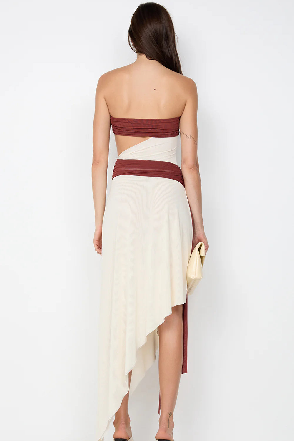 Back view of rust strapless maxi dress featuring clean fitted finish and elegant structured silhouette