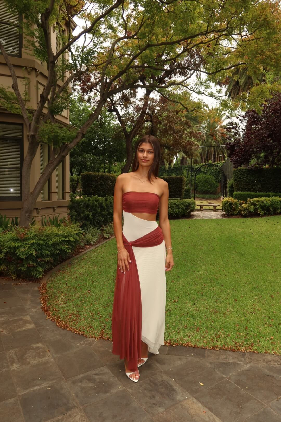 BEC + BRIDGE Ayla Strapless Dress in rust featuring a sleek strapless neckline and elegant full-length silhouette