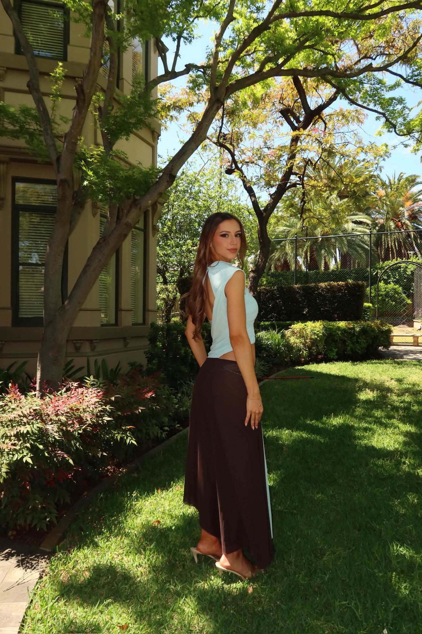 BEC + BRIDGE Conni Asym Midi Dress in blue and dark choc showcasing the elegant back design and fitted midi silhouette