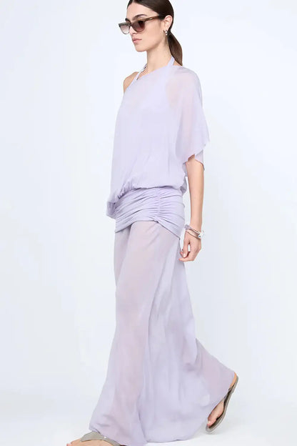 Close detail of waist on purple maxi dress showing gathered draping and sheer overlay creating a flattering fitted silhouette