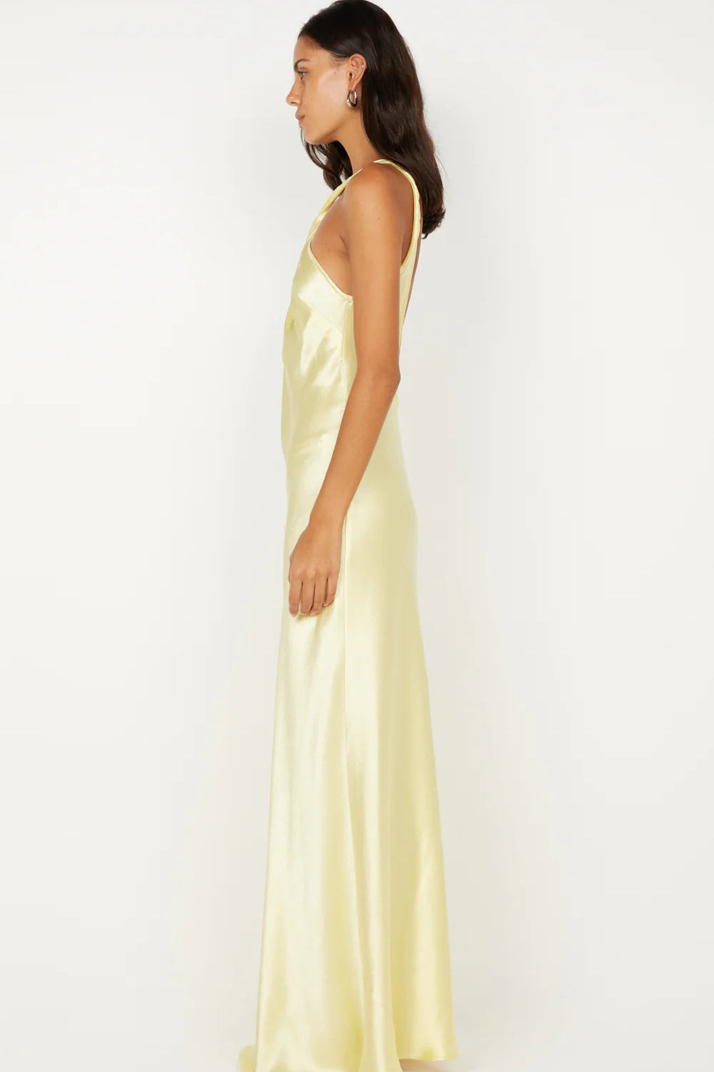 Side profile of ice yellow maxi dress showing bias cut silhouette and body skimming fit