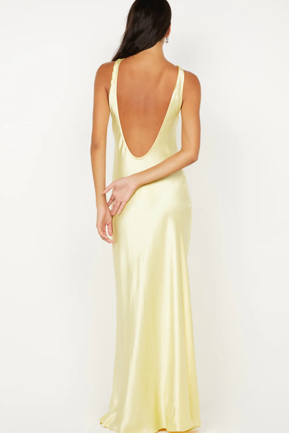 Back view of Bec & Bridge Elisia Twist Maxi Dress in ice yellow showing low scoop back and fitted silhouette