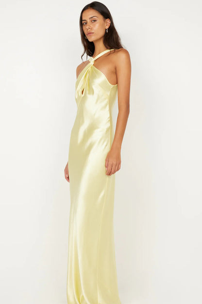 Side profile of ice yellow maxi dress showing bias cut silhouette and body skimming fit