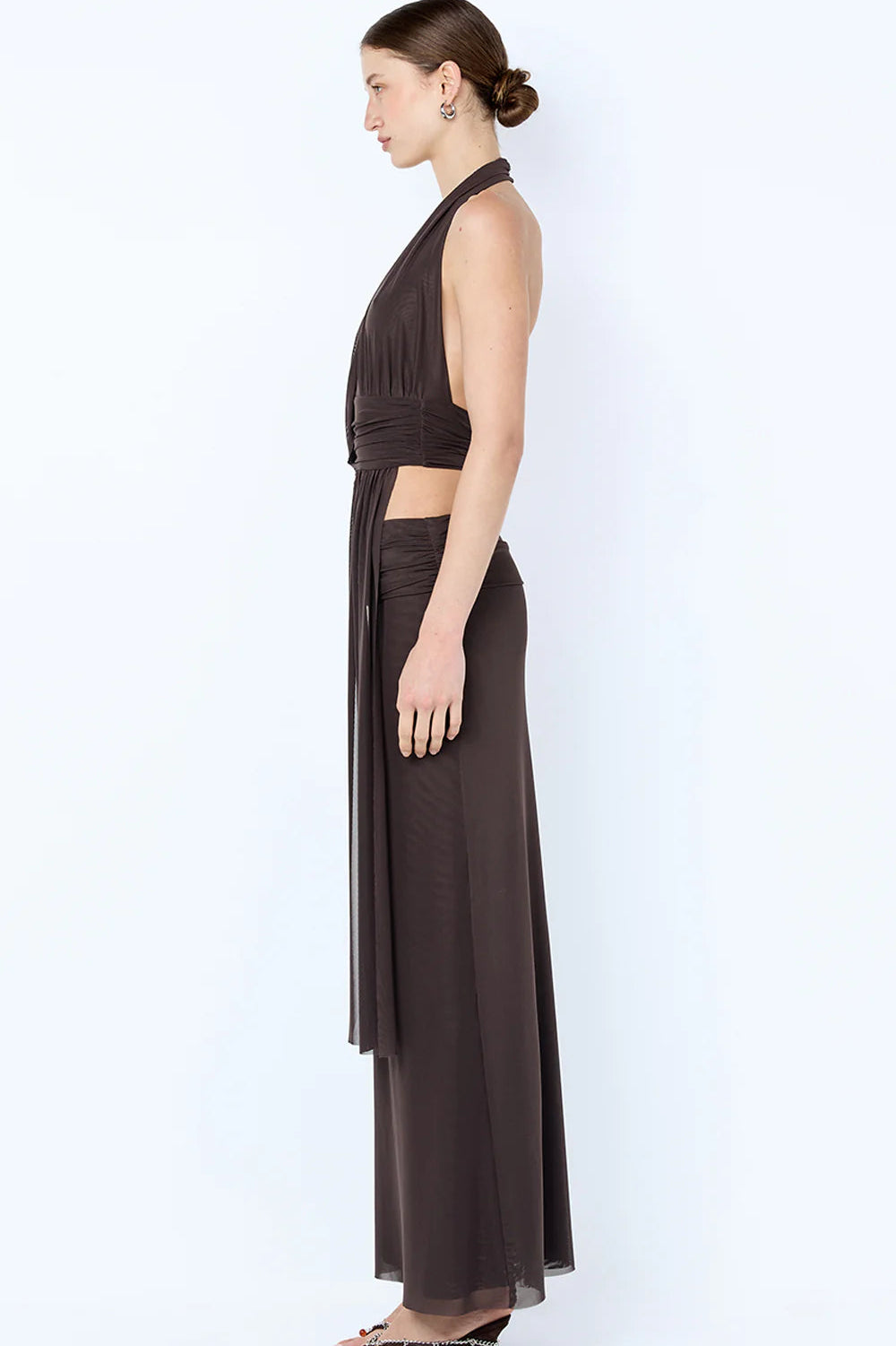 Side profile of brown Bec & Bridge set showing fitted drape top and flowing maxi skirt silhouette