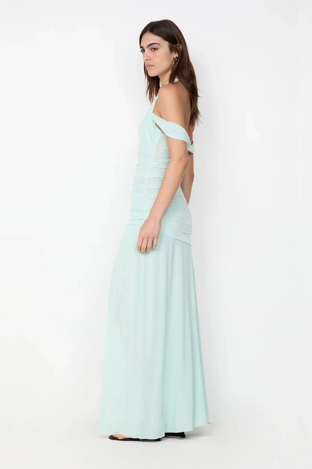 Side profile of spearmint maxi dress showing body skimming fit and flowing floor length silhouette
