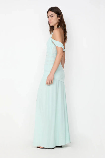 Side profile of spearmint maxi dress showing body skimming fit and flowing floor length silhouette