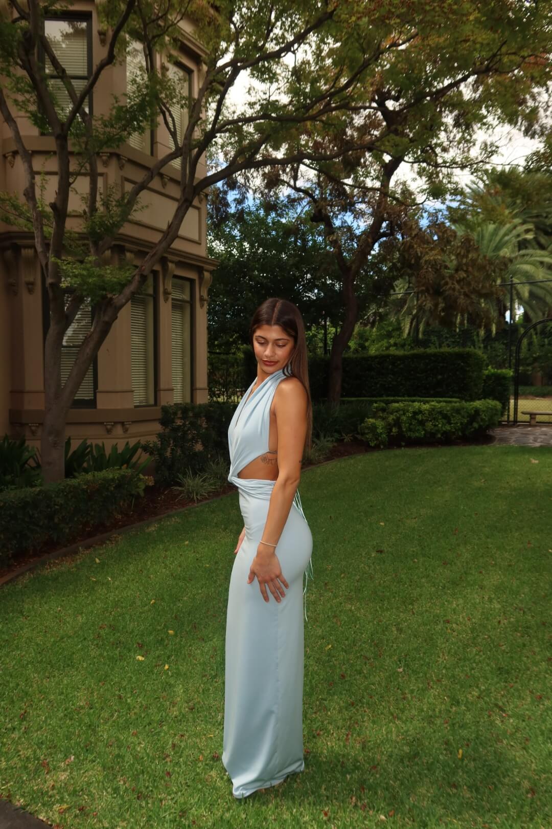 Side view of the Deconduarte Elin Maxi Dress in baby blue showcasing the flattering fitted silhouette