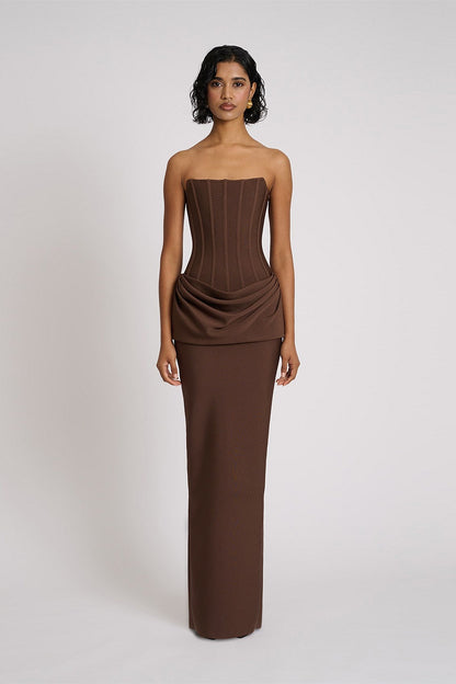Eliya The Label Hilda Gown in chocolate featuring strapless neckline, structured corset bodice and elegant floor length silhouette with soft draped fabric
