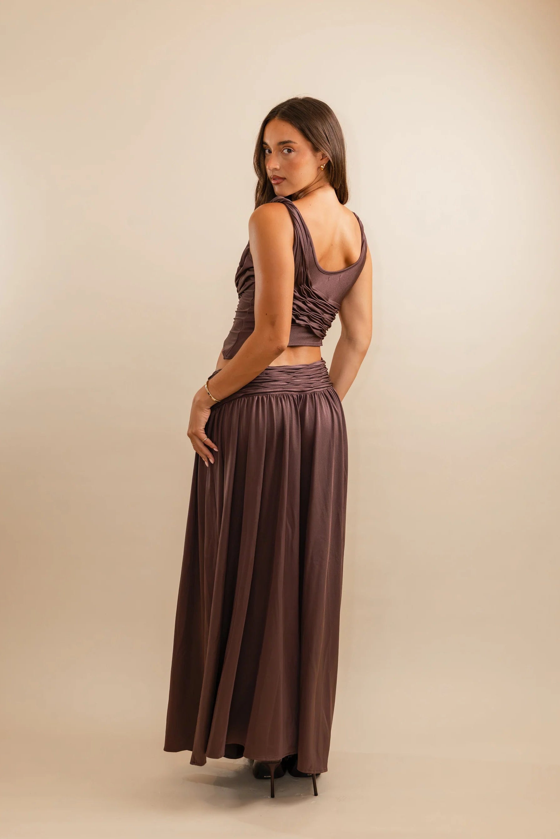 Back view of Koster Kulture Calypso Set in plum showing fitted crop top and smooth stretch maxi skirt silhouette