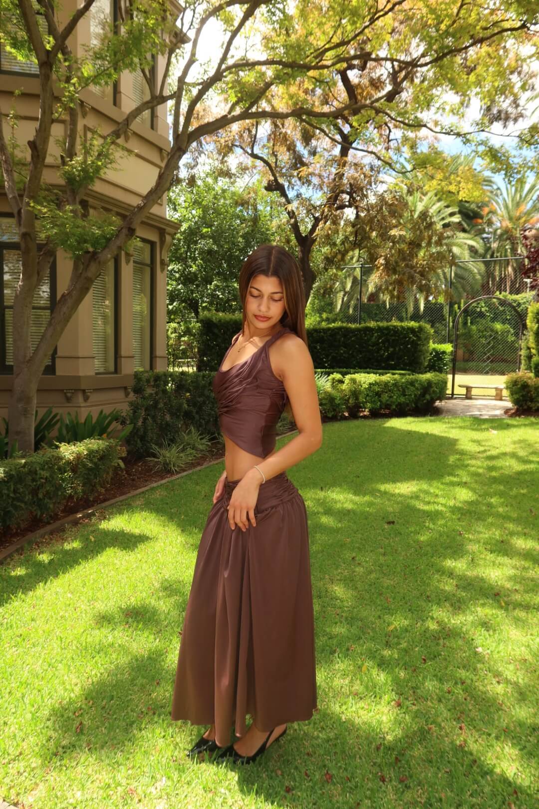 Side view of the Koster Kulture Calypso Set in plum showcasing the elegant drape and coordinated two-piece design