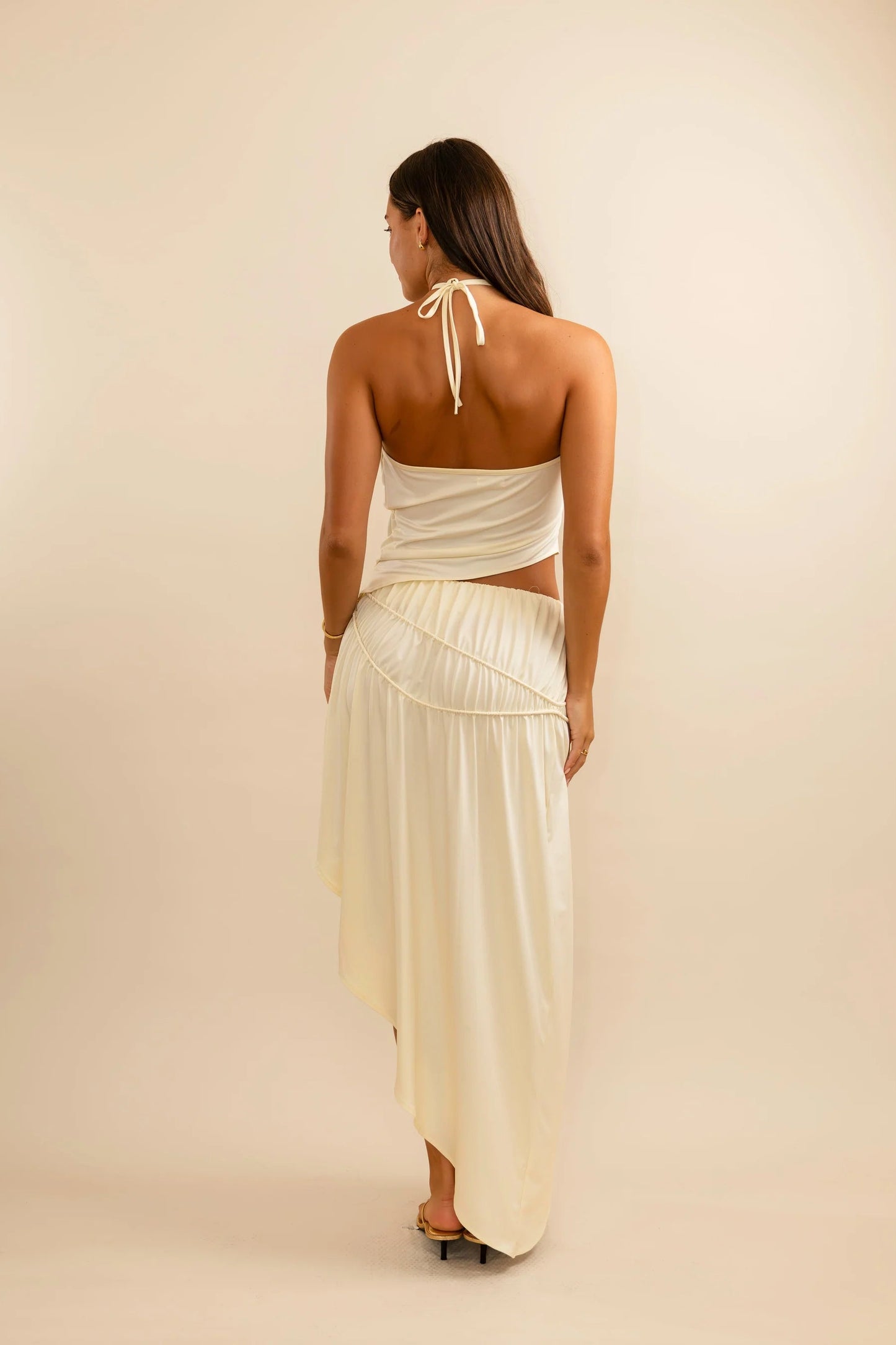 Back view of Koster Kulture Fleur Set in cream showing fitted halter top and clean streamlined skirt silhouette