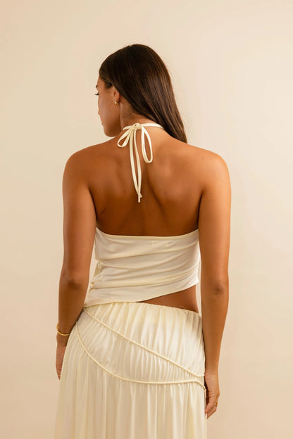 Close detail of structured halter bodice on cream set showing tailored fit and elegant neckline shaping