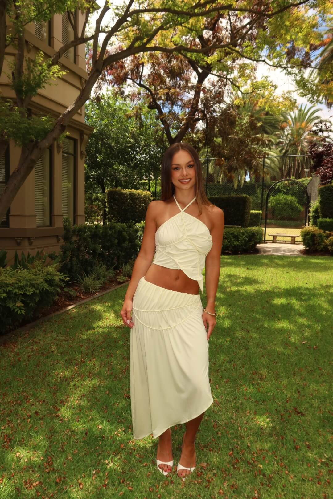 Three-quarter front view of the Koster Kulture Fleur Top and Skirt Set in cream showcasing the coordinated two-piece silhouette