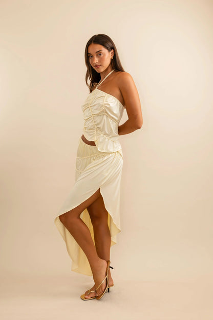 Koster Kulture Fleur Set in cream featuring sculpted halter top and asymmetrical skirt with elegant structured silhouette for formal occasions