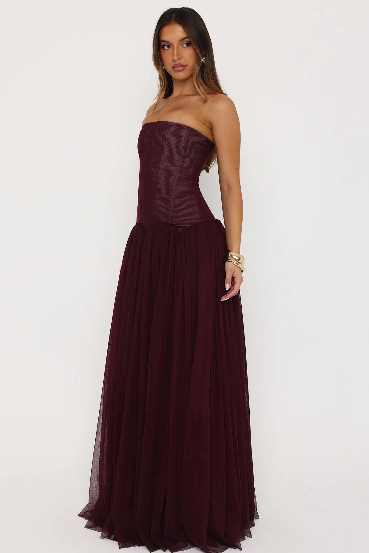 Front view of structured corset bodice with internal boning and grip tape support on fig coloured formal maxi dress