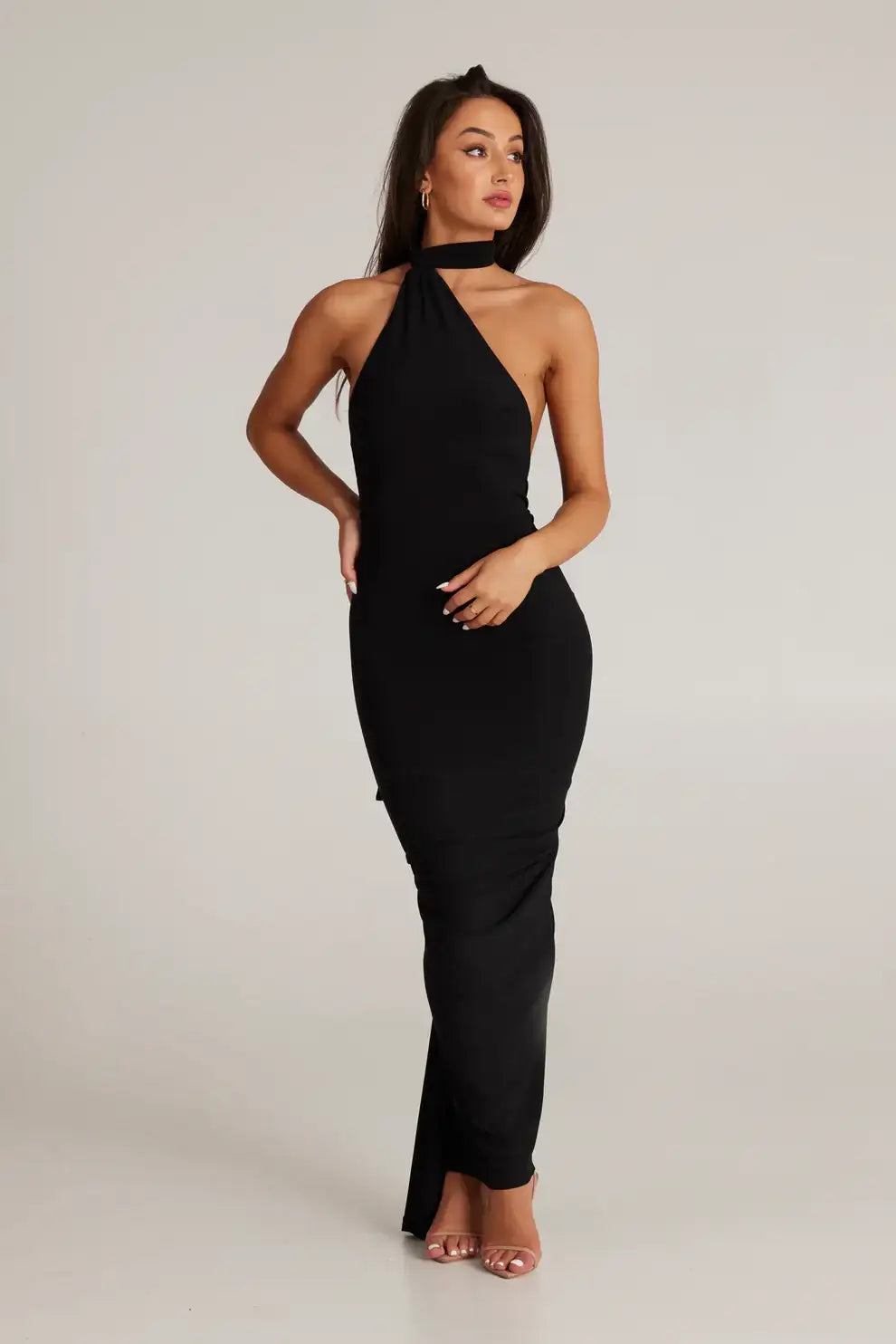 Melani The Label Leoni Dress in black featuring high neckline, long sleeves and elegant floor length fitted silhouette