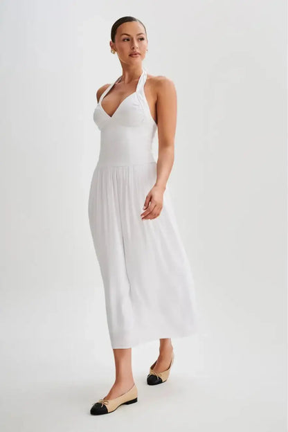 Close detail of cinched waist on white halter midi dress showing sculpted fit and gathered skirt volume