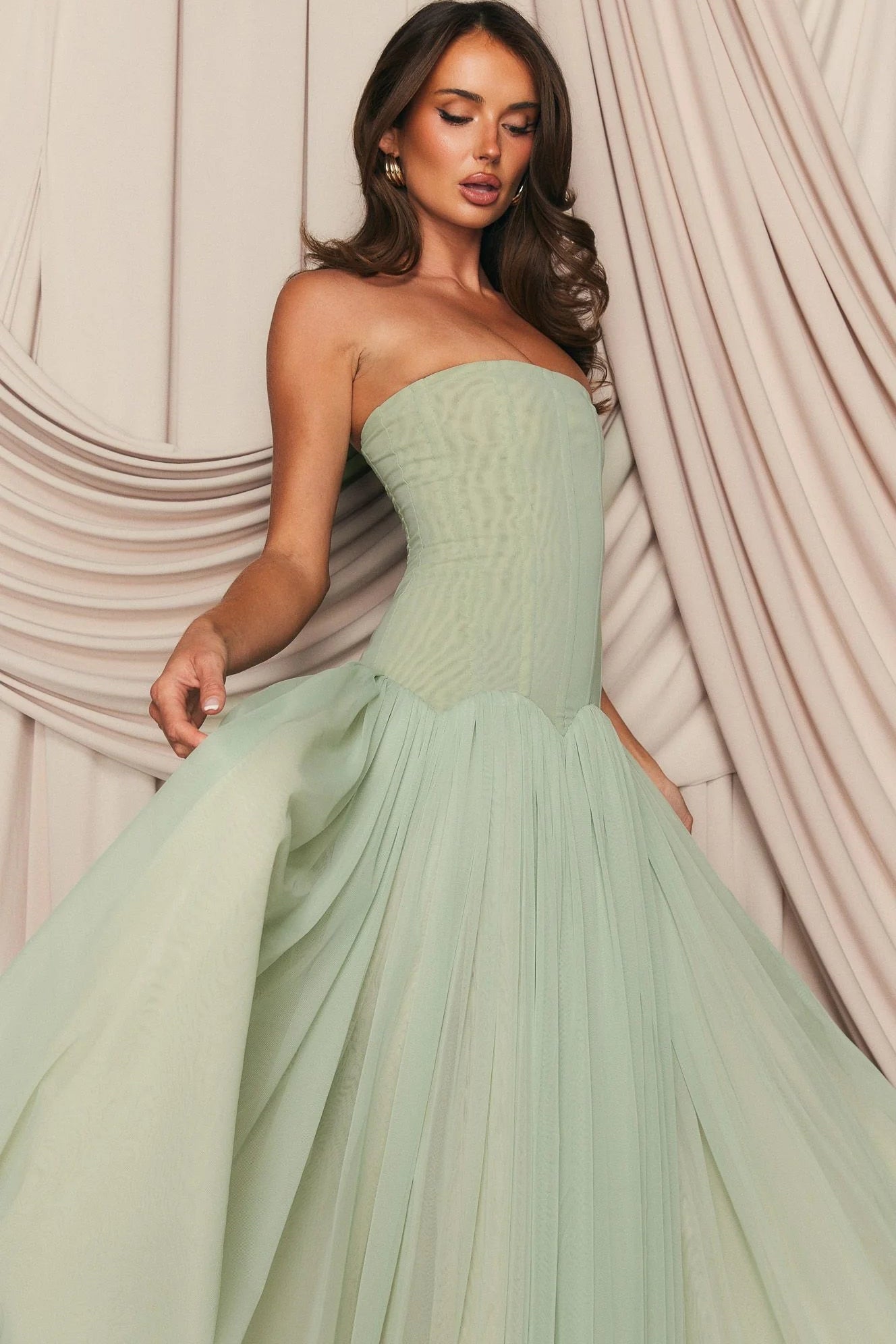 Elegant mint green formal maxi dress styled with heels and minimal jewellery for wedding guest or formal occasion