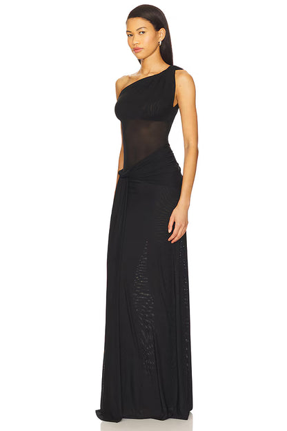 Side profile of black mesh maxi dress showing body skimming fit and asymmetrical draped silhouette with flowing fabric