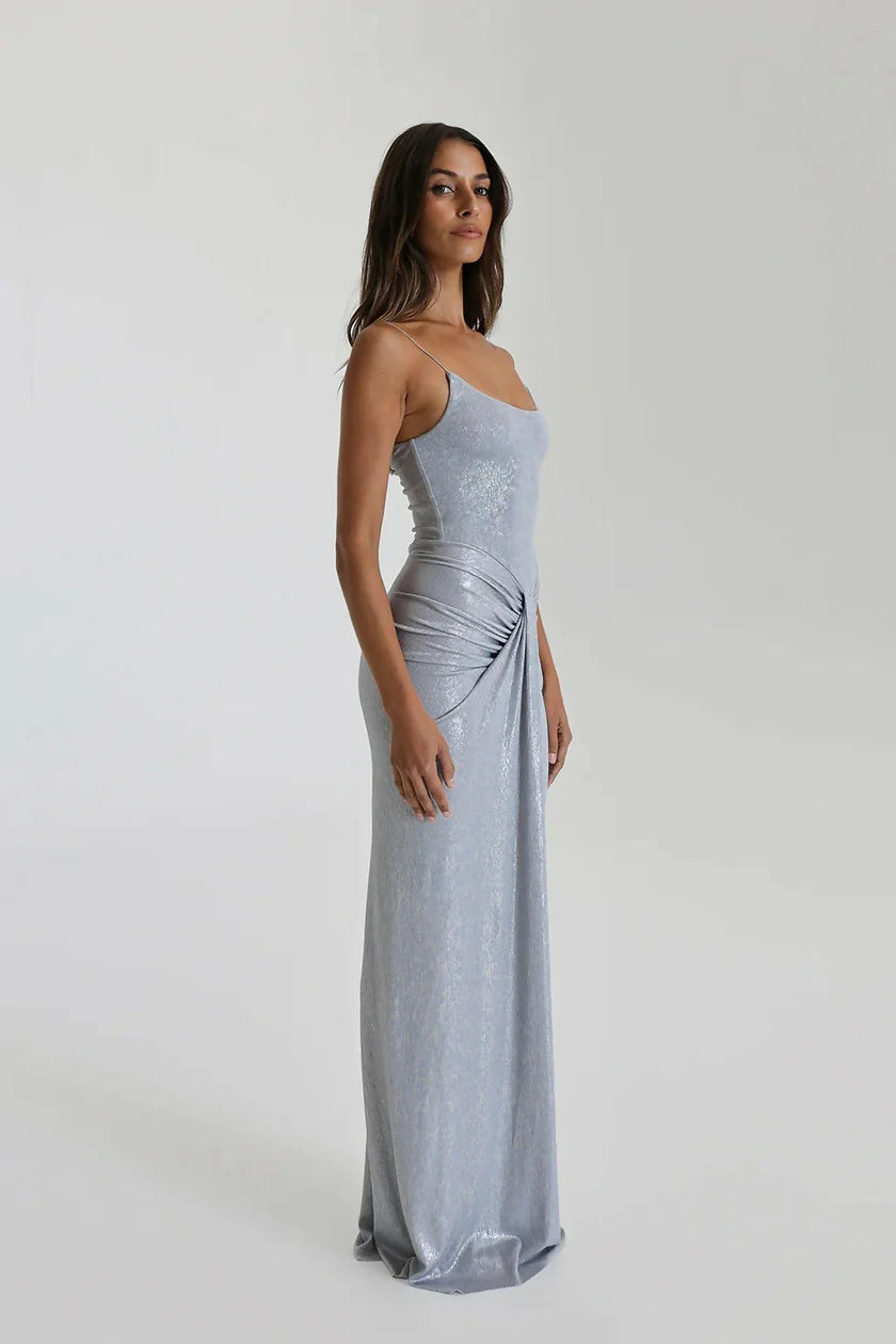 Natalie Rolt Allora Gown in silver featuring scooped neckline, waterfall drape detail and flowing floor length metallic silhouette for formal occasions