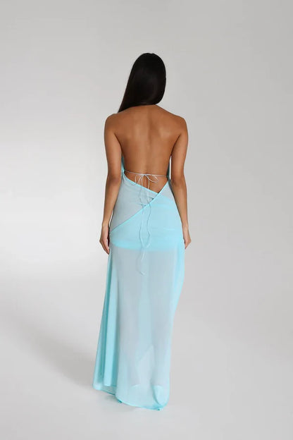 Back view of Natalie Rolt Anastasia Maxi Dress in baby blue featuring open back design, halter tie detail and flowing draped georgette fabric with elegant soft silhouette