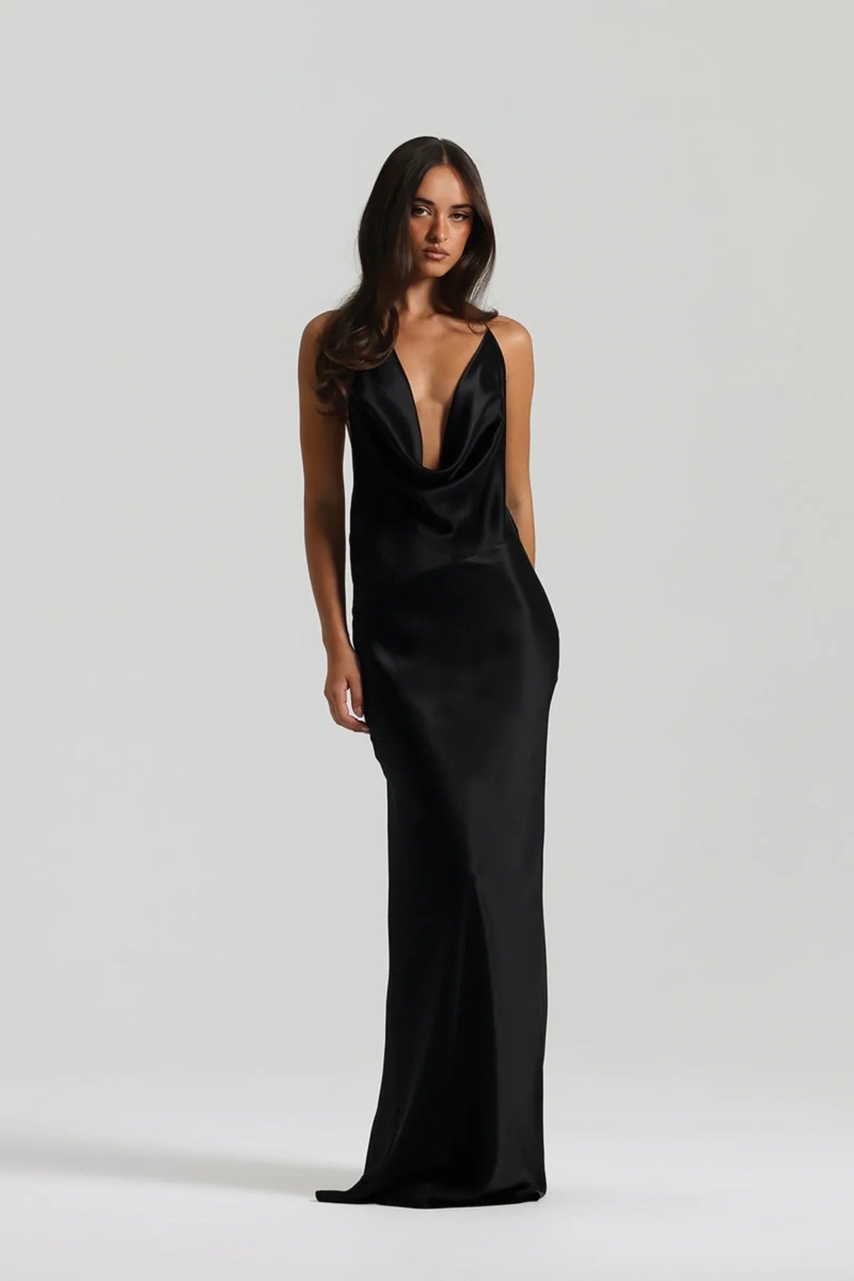 Natalie Rolt Gabi Gown in black featuring bias cut silk fabric, asymmetrical draped neckline and elegant floor length silhouette with soft fluid finish