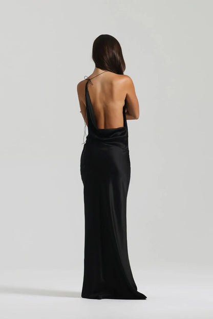 Close detail of waist on black silk gown showing fluid drape and softly structured asymmetrical design line
