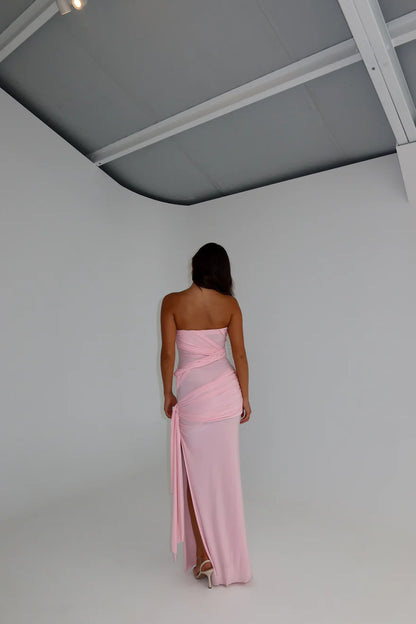 Back view of blossom pink gown featuring strapless fitted design and smooth draped finish with elegant seamless silhouette