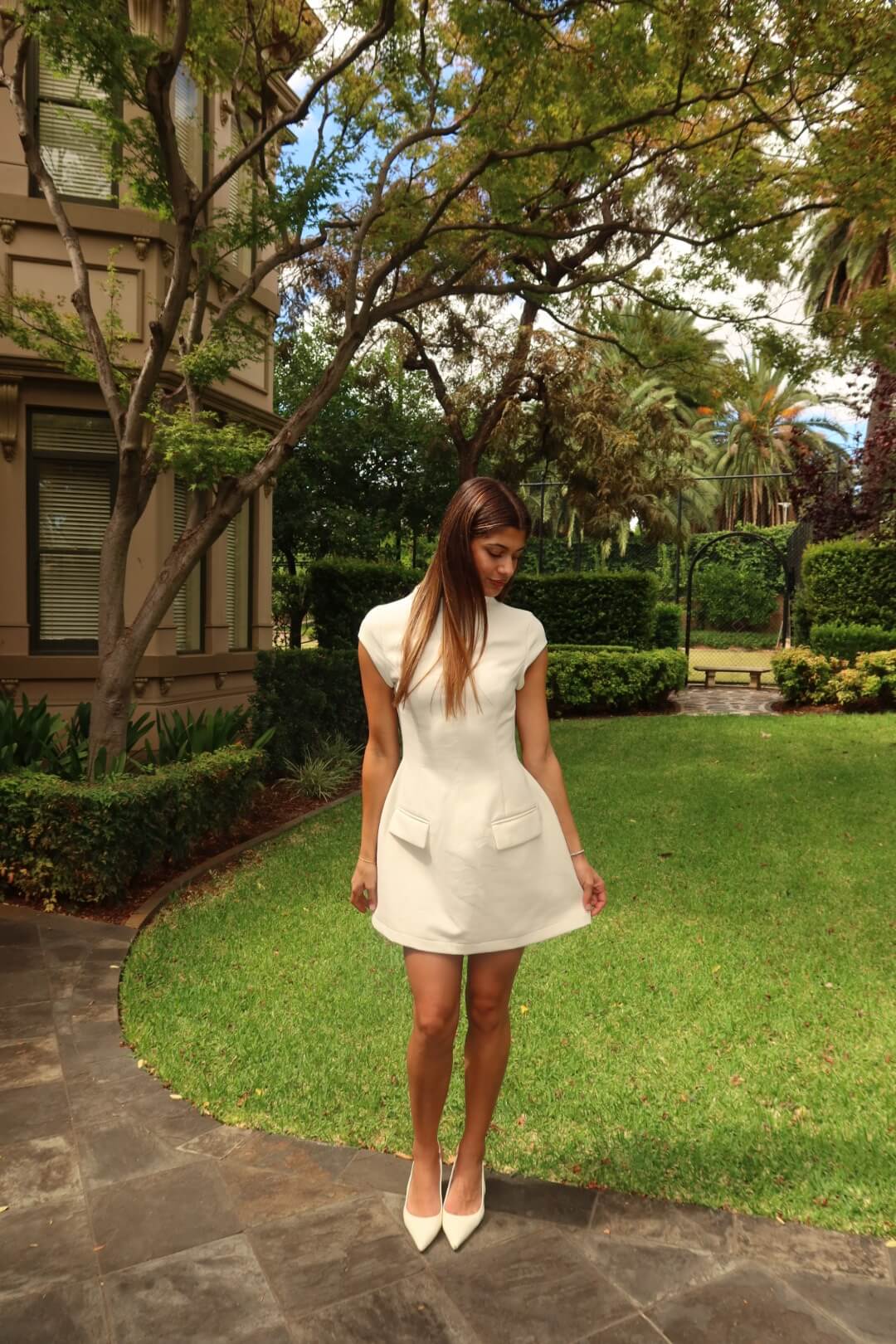 Close-up of the Odd Muse Ultimate Muse Cap Sleeve Mini Dress in white highlighting the cap sleeves, neckline and tailored bodice