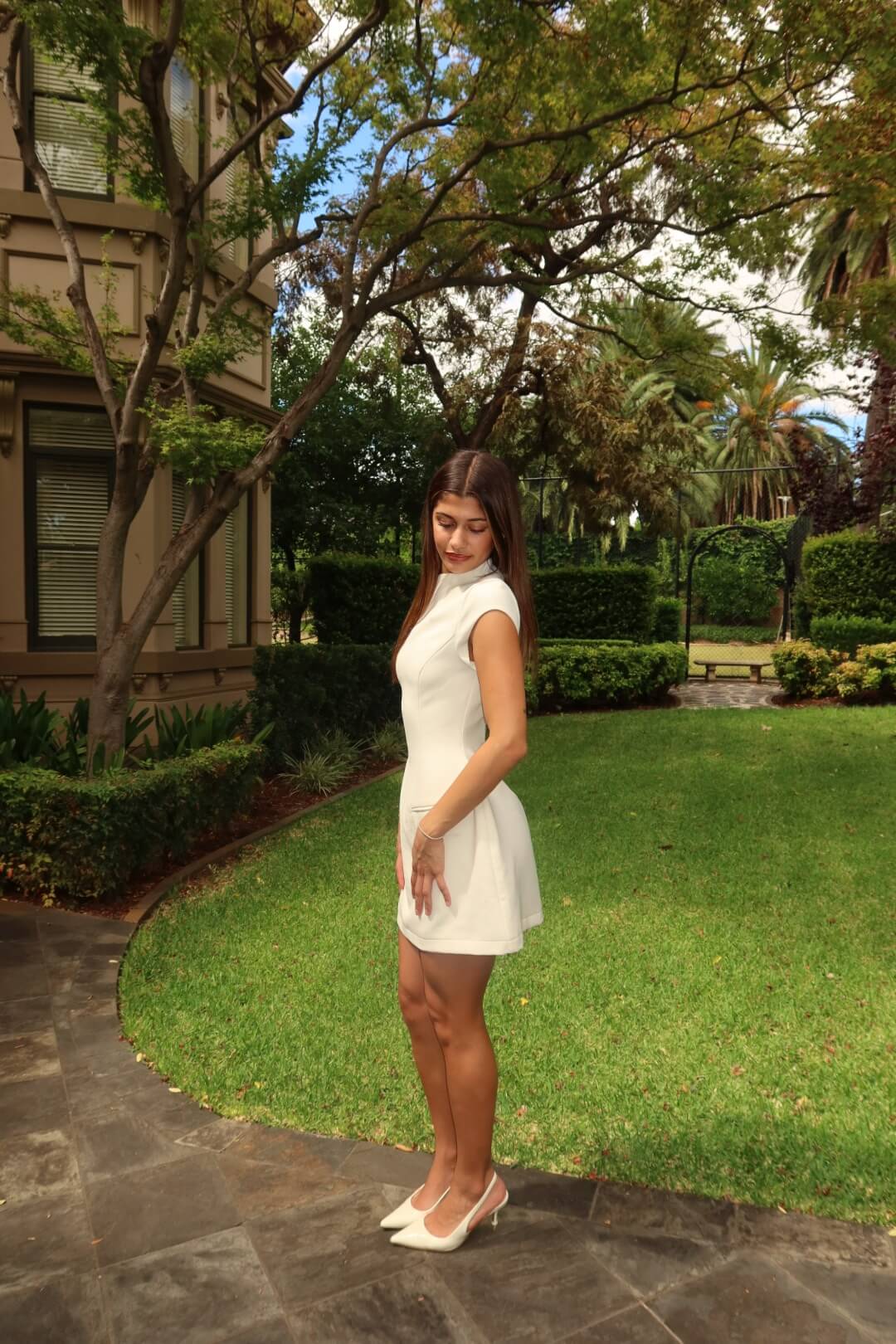 Side view of the Odd Muse Ultimate Muse Cap Sleeve Mini Dress in white showcasing the flattering tailored mini silhouette
