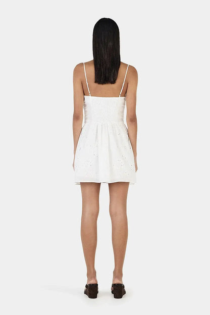 Back view of Ownley Yash Mini Dress in white featuring a fitted strapless bodice, embroidered broderie anglaise fabric, invisible zip closure and softly flared mini skirt