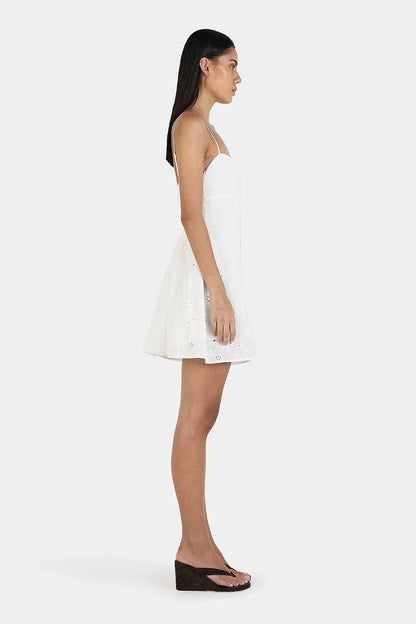 Back view of Ownley Yash Mini Dress in white featuring fitted strapless bodice, embroidered anglaise fabric and feminine mini silhouette