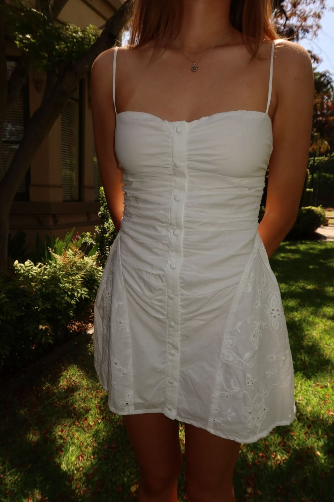 Close-up of the Ownley Yash Mini Dress in white anglaise highlighting the embroidered fabric and neckline detail