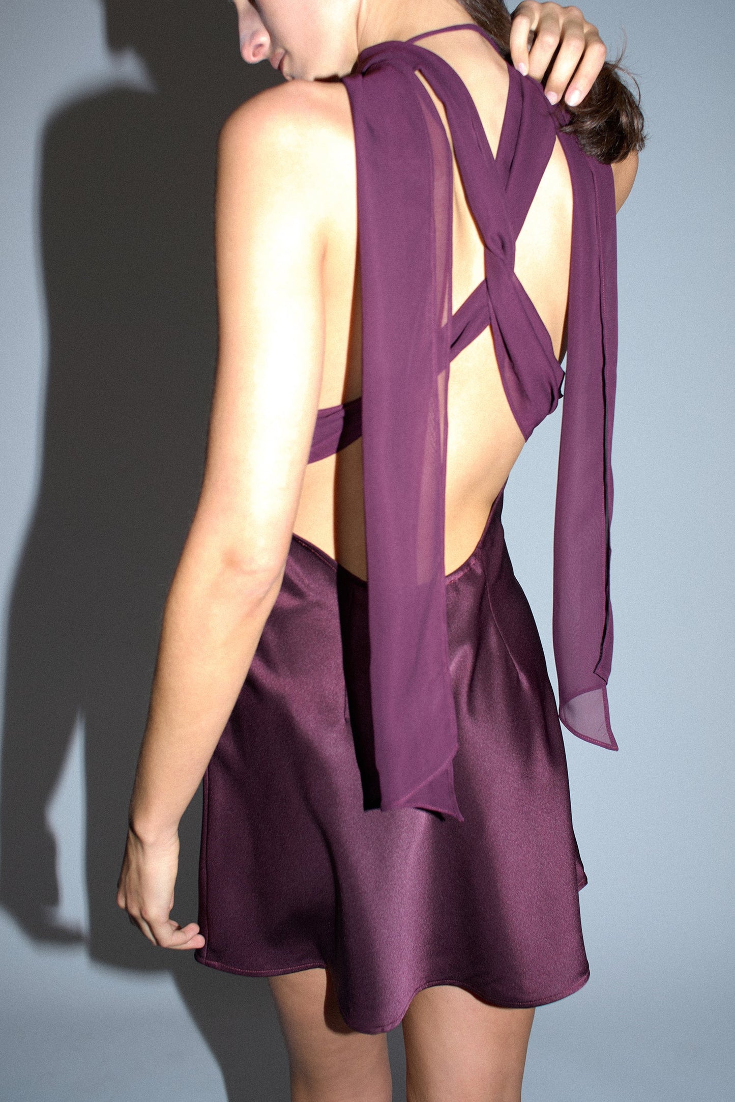 Plum brown mini dress back detail highlighting the sleek fitted design and sophisticated evening wear styling