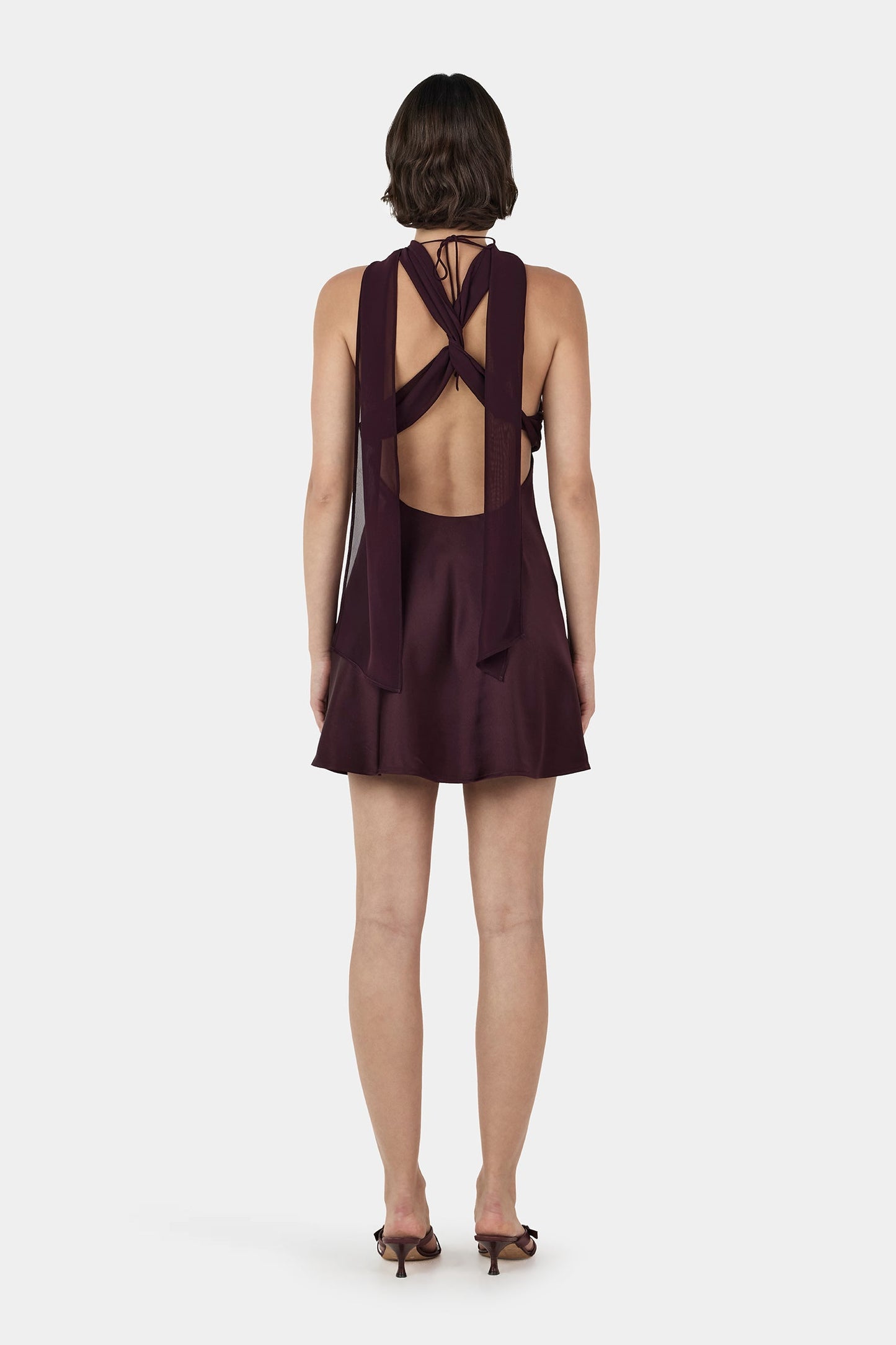 Back view of Ownly Alanah Two Way Mini Dress in plum brown showcasing an elegant fitted silhouette and feminine design