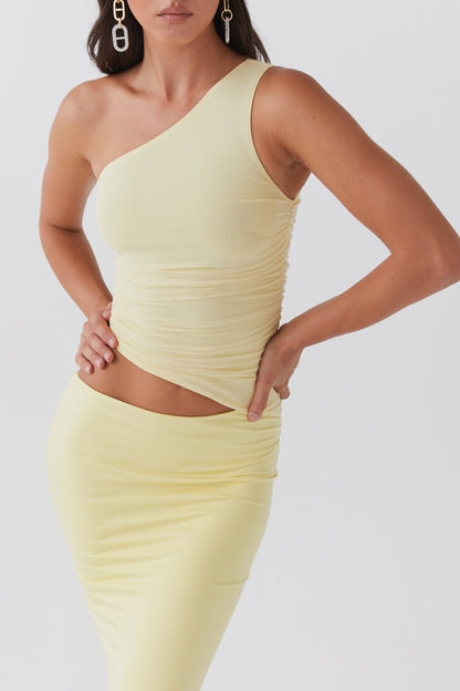 Yellow maxi dress with one shoulder design, ruched mesh bodice and waist cut out creating a sculpted fitted silhouette